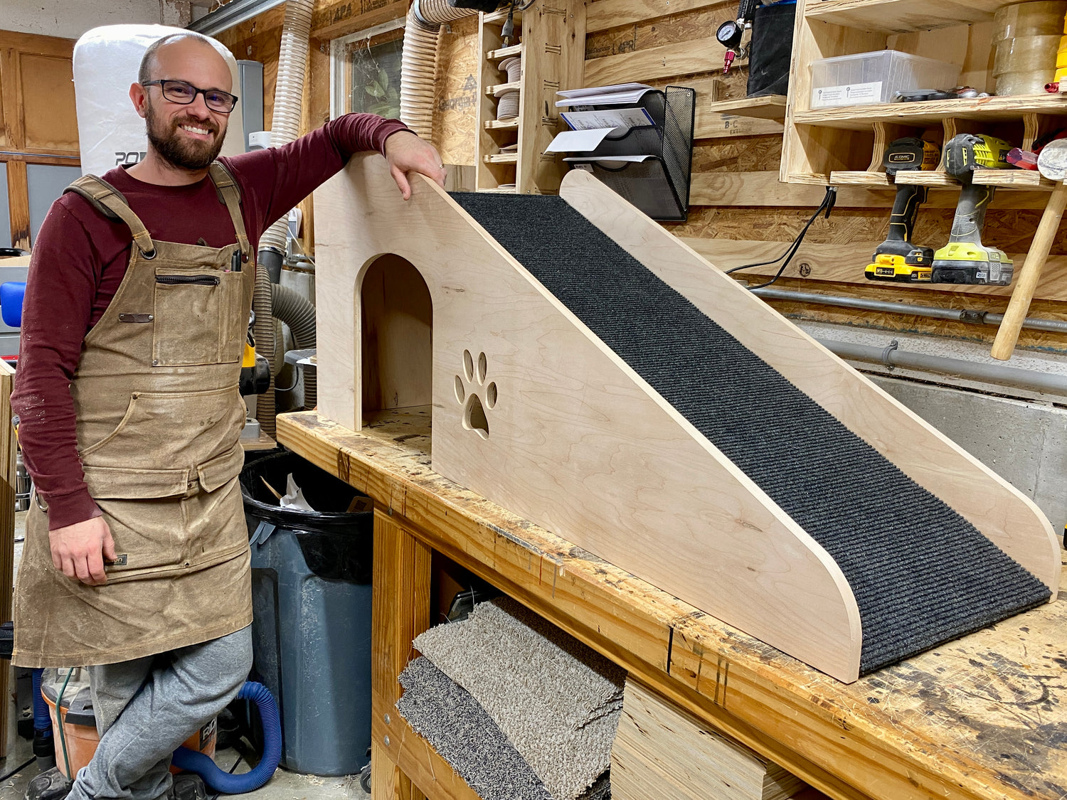 john chretien standing next to pet ramp he built
