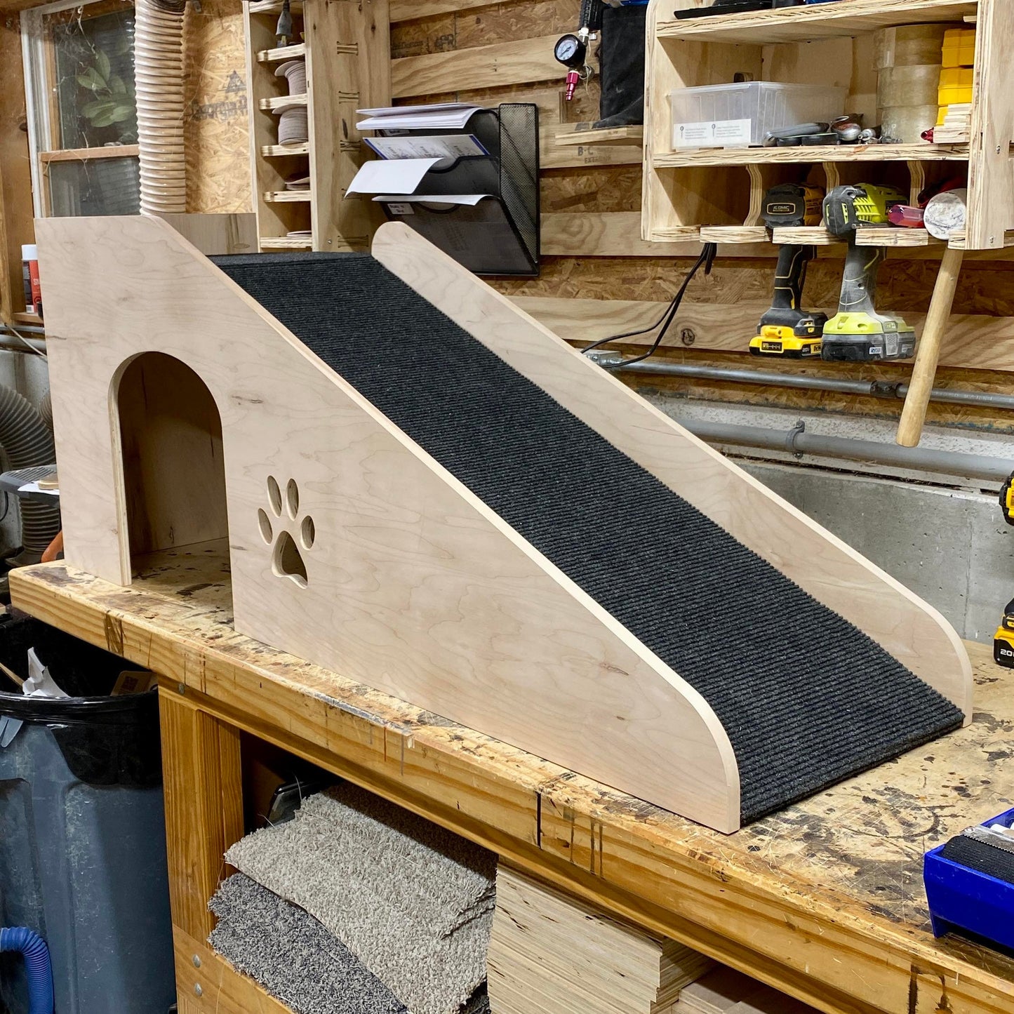 Image of our 20-inch pet ramp with platform showcased in our shop, featuring a natural wood finish and a black indoor/outdoor rug for added durability and traction.